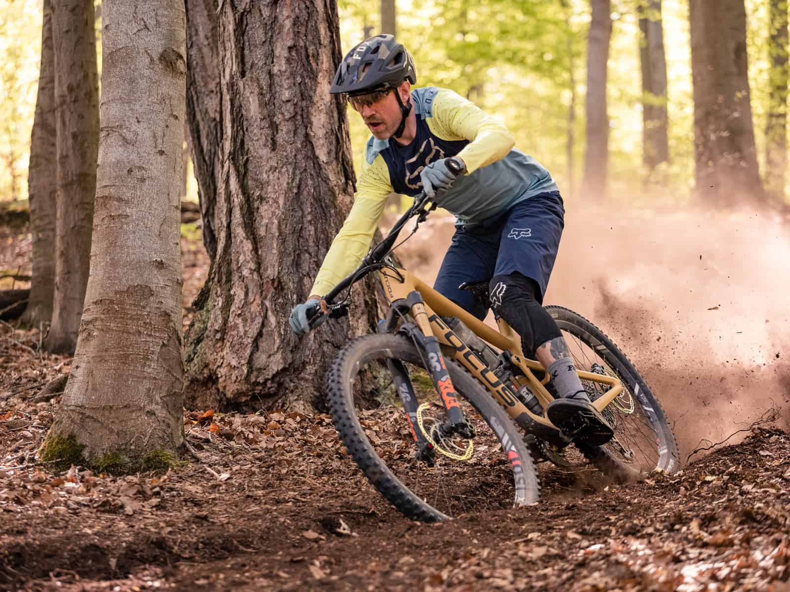 Illustratieve foto van een fietser die op een mountainbike door het bos fietst